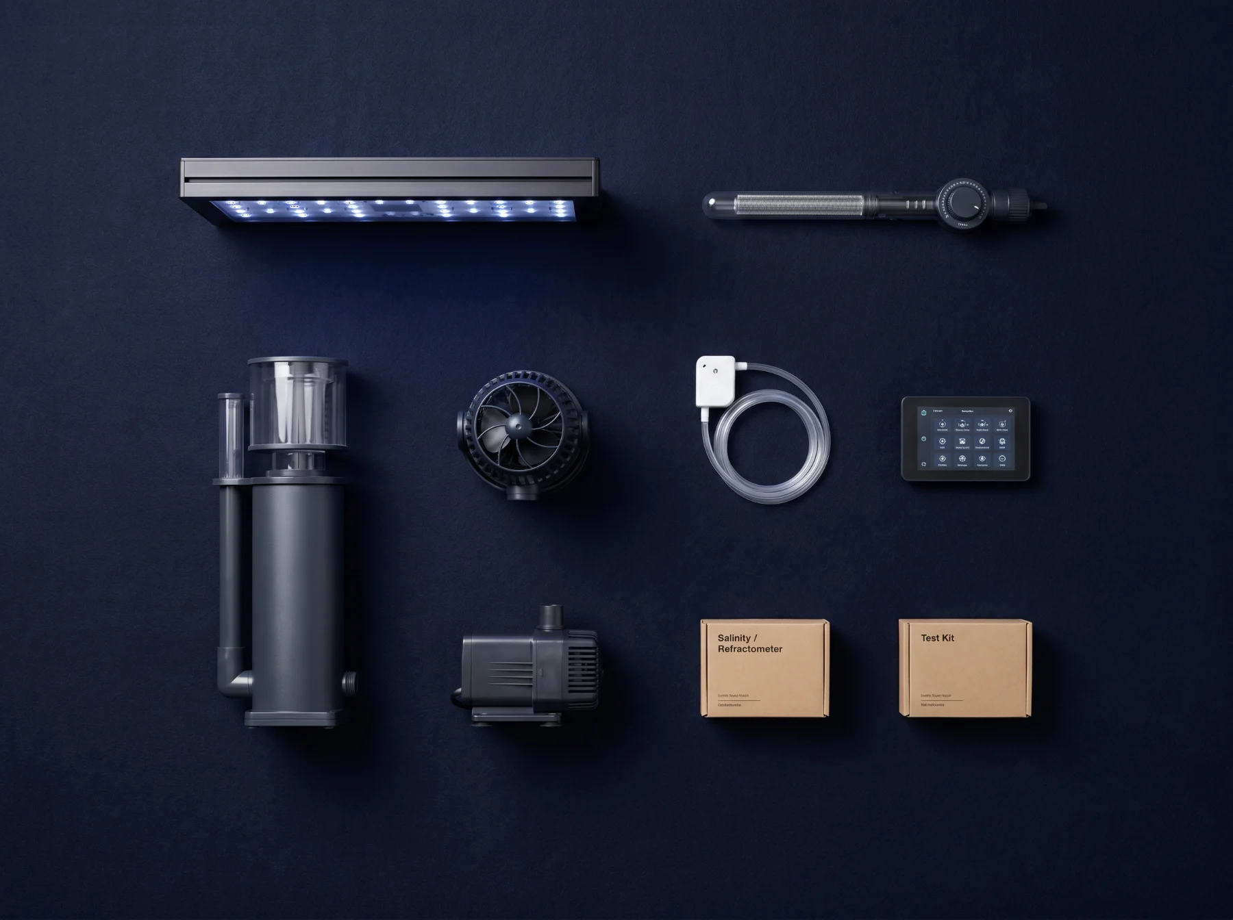 Overhead flat-lay of reef equipment on deep-navy: LED light, protein skimmer, wave pump, return pump, heater, auto top-off, controller, and test kits.